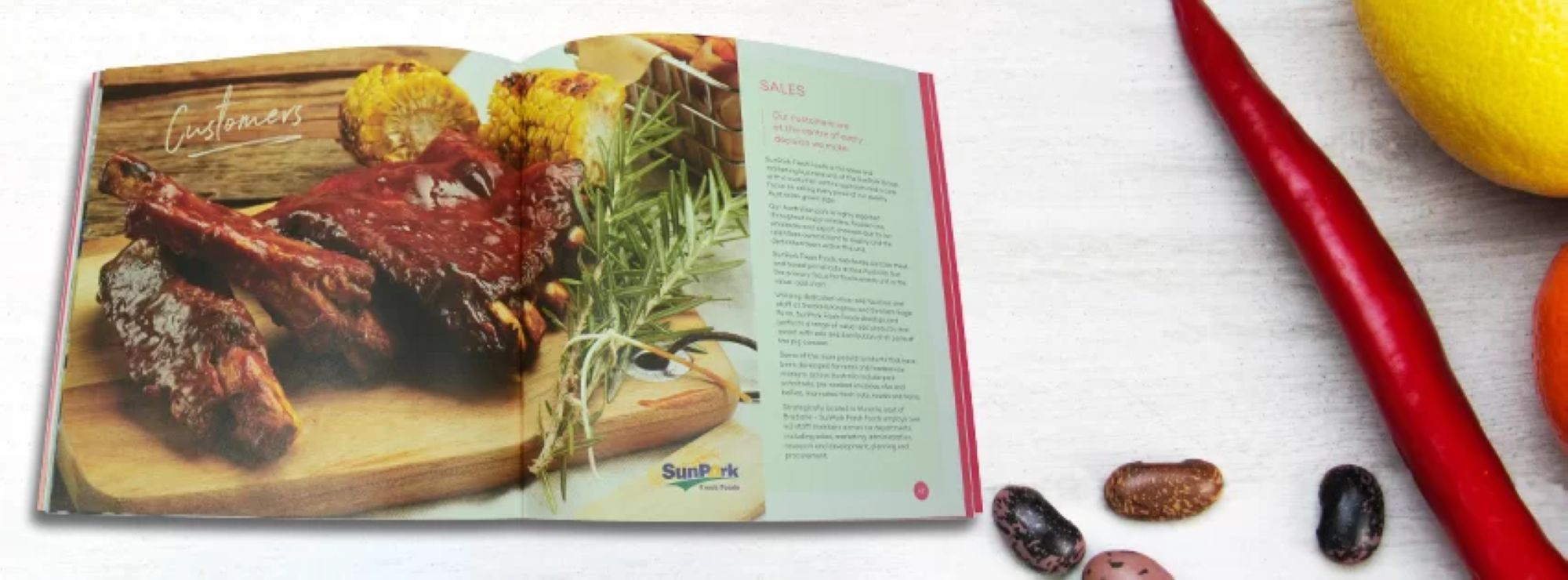 Recipe book with cooked steak image, and ingredients on the table