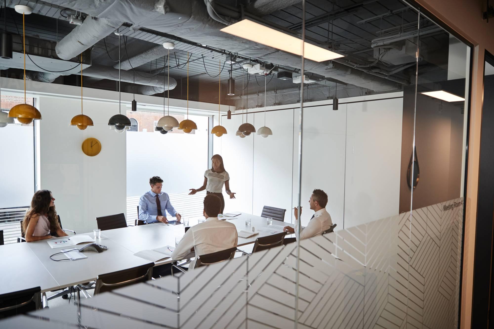 businesswoman giving boardroom presentation viewed